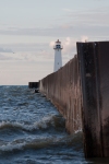 A photo looking out the retaining wall towards Sodus Point Lighthouse, Sodus, NY